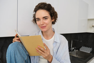 Young woman using digital tablet at home