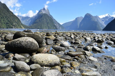 Scenic view of sea and mountains against sky