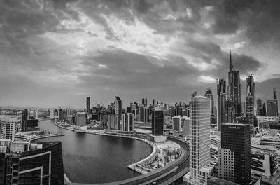 View of cityscape against cloudy sky