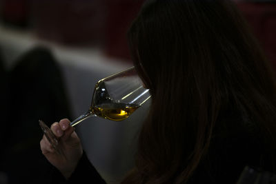 Close-up portrait of a woman drinking glass