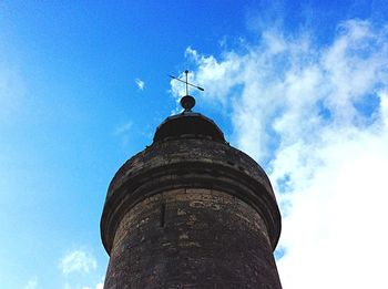 Low angle view of tower against cloudy sky