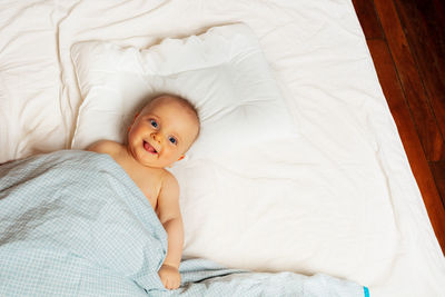 High angle view of baby boy sleeping on bed at home