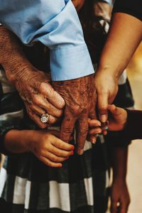 Midsection of couple holding hands