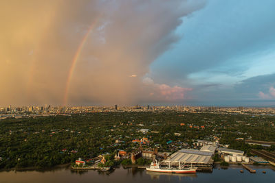 High angle view of rainbow over buildings in city