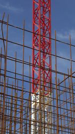 Low angle view of crane against blue sky