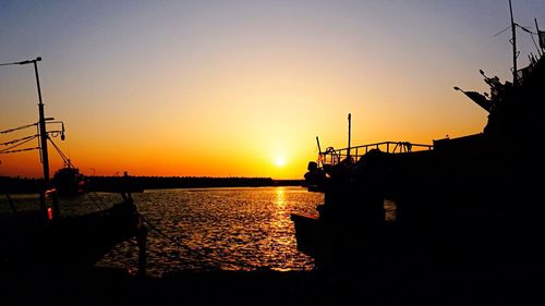 Boat in sea at sunset