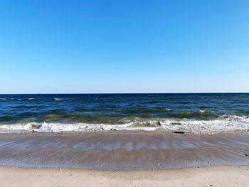 Scenic view of sea against clear blue sky