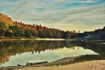 Scenic view of lake against sky at sunset