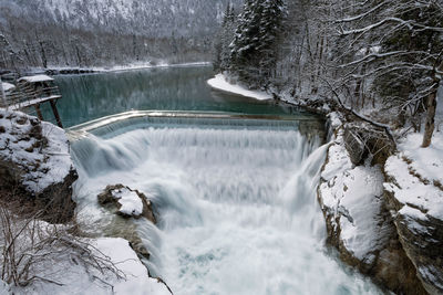 Scenic view of waterfall in forest during winter