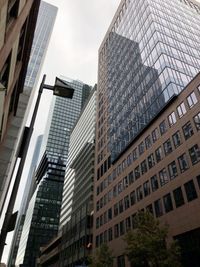 Low angle view of modern buildings against sky in city