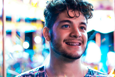 Close-up of smiling young man looking away