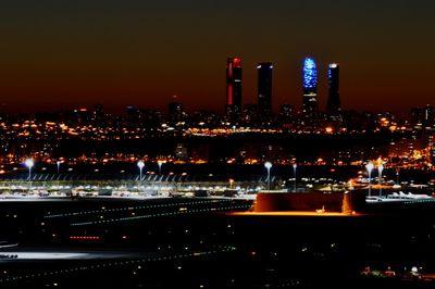 High angle view of illuminated buildings in city at night