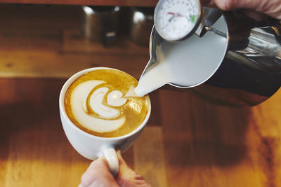 Cropped image of person holding coffee cup