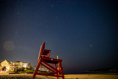 Traditional windmill against sky at night