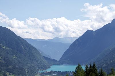 Scenic view of river and mountains against sky