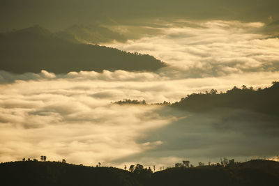 Scenic view of dramatic sky over silhouette landscape