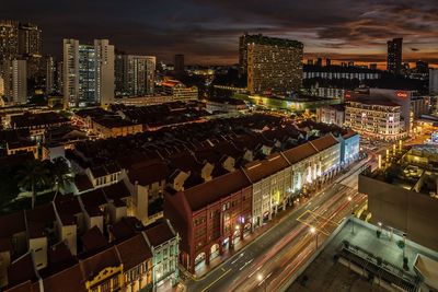 High angle view of illuminated cityscape against sky at night