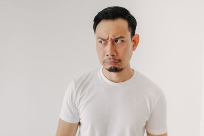 Portrait of young man against white background