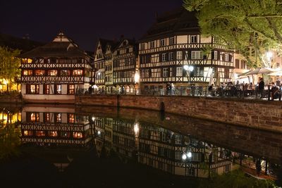 Reflection of buildings in city at night