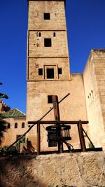 Low angle view of historic building against clear blue sky