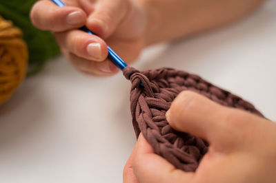 Close-up of hand holding sewing needle