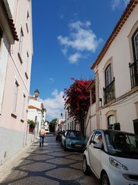 Street amidst buildings in city against sky