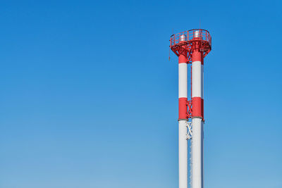 Factory chimney, copy space. red and white. industrial pipe without smoke, harmful emissions