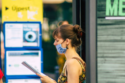 Portrait of young woman using mobile phone