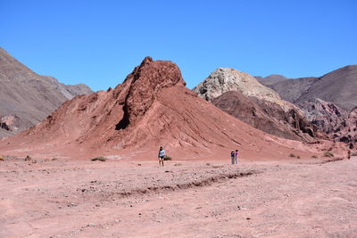 Scenic view of desert against clear blue sky