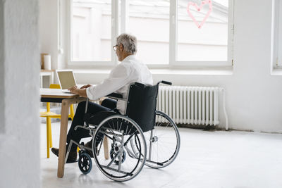 Handicapped manager in a wheelchair, working in office