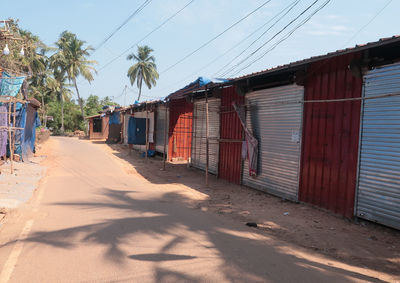 Houses by road against sky in city