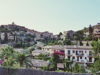 Buildings in town against clear sky