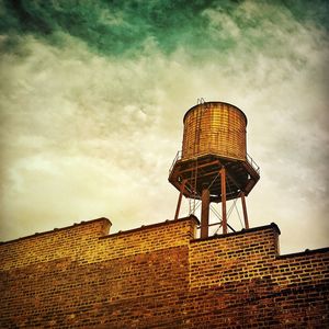 Low angle view of built structure against cloudy sky