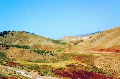 Scenic view of mountains against clear blue sky