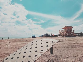 People walking on beach against sky