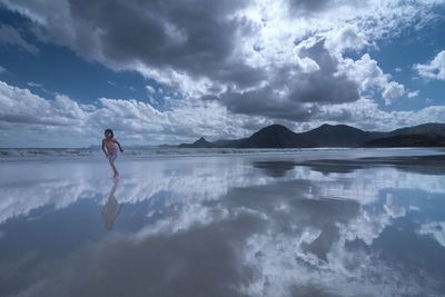 Full length of man in lake against sky