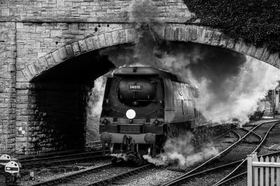 Train on railroad track in tunnel