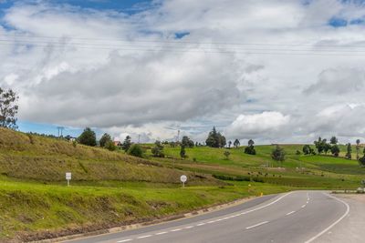 Road passing through landscape against sky