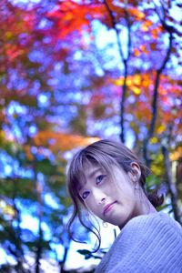 Portrait of girl against tree