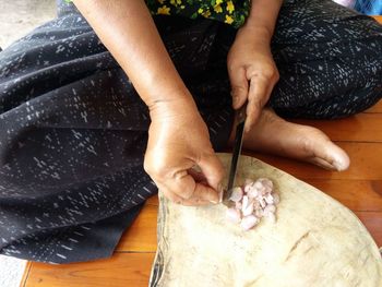 Midsection of woman working on table