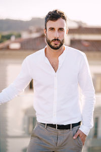 Portrait of young man standing outdoors