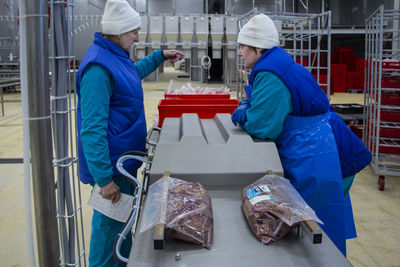 Rear view of man working in factory