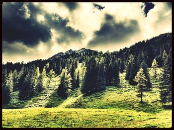 Scenic view of mountains against cloudy sky