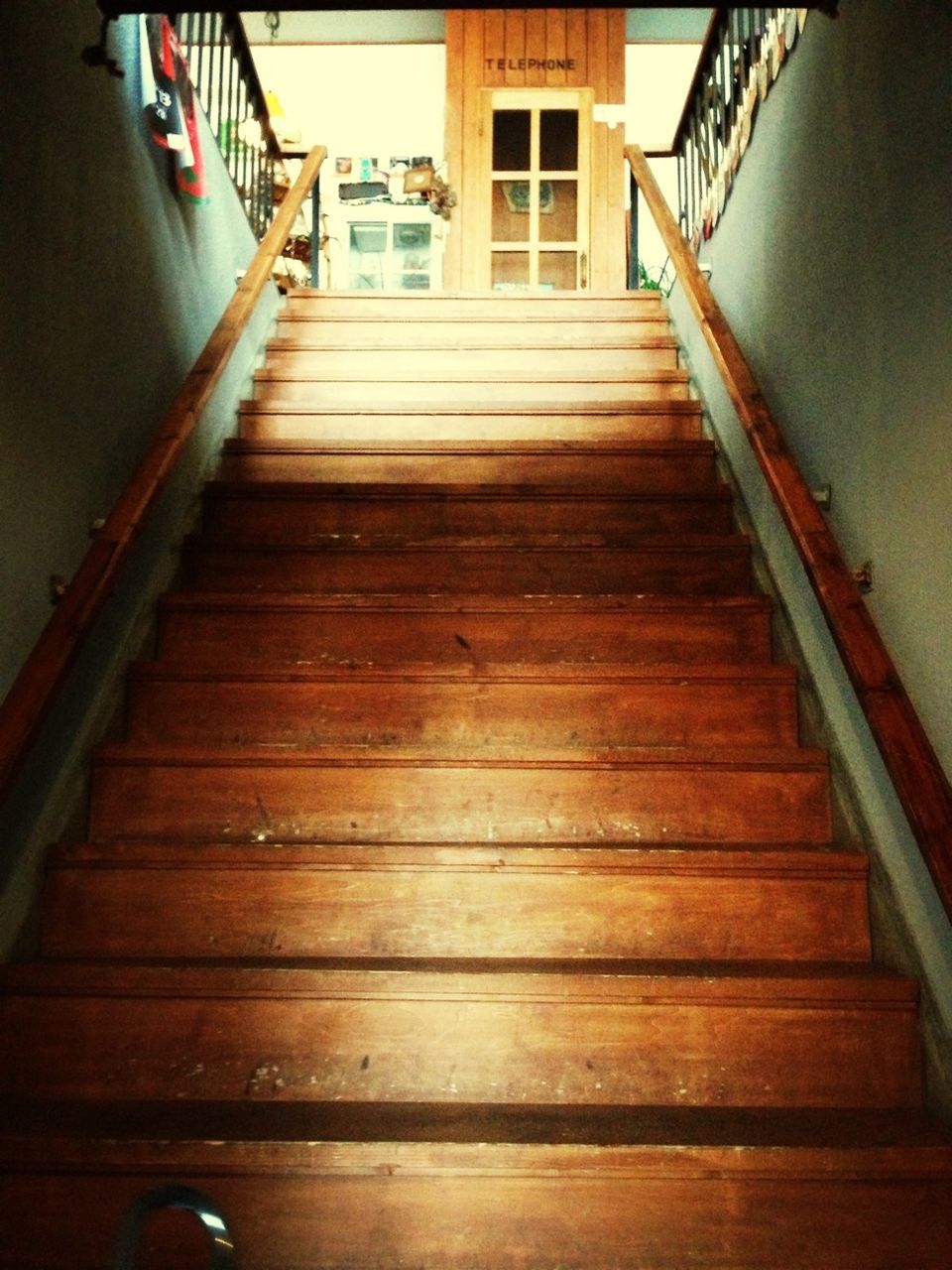 indoors, wood - material, architecture, built structure, steps, staircase, hardwood floor, railing, steps and staircases, door, house, wooden, high angle view, wood, empty, sunlight, no people, flooring, absence, the way forward