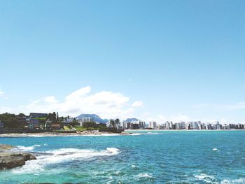 Scenic view of sea and buildings against sky