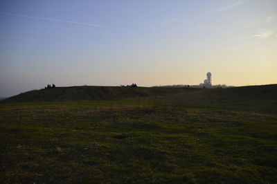 Scenic view of field against sky during sunset