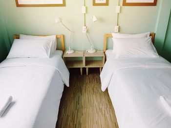 High angle view of neat beds in room