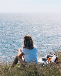 Rear view of woman in sea against sky