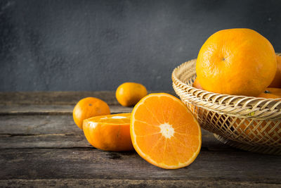 Close-up of orange fruits in basket on table