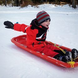 Girl playing on snow field